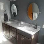 bathroom remodel vanity with round mirror