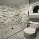 bathroom remodel shower with grey multi-colored tiles